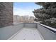 This balcony features a view of nearby buildings and evergreen trees at 1437 Garfield St, Denver, CO 80206