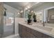 This spa-like bathroom features double sinks, a quartz countertop and a seamless glass shower at 1437 Garfield St, Denver, CO 80206