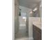 A frameless glass shower enclosure highlights the elegant tile work and rainfall shower head in this bathroom at 1437 Garfield St, Denver, CO 80206