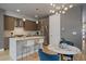 Modern kitchen with stainless steel appliances, a center island, and an adjacent dining area at 1437 Garfield St, Denver, CO 80206