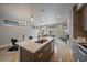 Open kitchen with stainless steel appliances and island flowing into living area at 1437 Garfield St, Denver, CO 80206