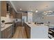 Spacious kitchen with stainless steel appliances, a center island, and modern fixtures at 1437 Garfield St, Denver, CO 80206