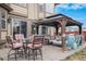 An outdoor patio features comfortable seating arrangements with stylish chairs and shaded pergola at 15776 E 107Th Way, Commerce City, CO 80022