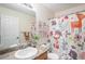 A bathroom features cartoon décor, a single sink vanity, and a shower and tub combination at 15776 E 107Th Way, Commerce City, CO 80022