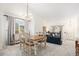 Bright dining room with modern chandelier and view of the living room at 15776 E 107Th Way, Commerce City, CO 80022
