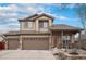 Charming two-story home with a three-car garage, covered front porch, and well-maintained landscaping offers curb appeal and functionality at 15776 E 107Th Way, Commerce City, CO 80022