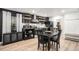 Modern black and white kitchen with sleek appliances, floating shelves and dining area at 15776 E 107Th Way, Commerce City, CO 80022