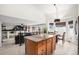 Open-concept kitchen with an island, granite countertops, and view of the adjacent living and dining areas, creating a connected space at 15776 E 107Th Way, Commerce City, CO 80022