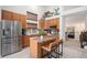 Well-lit kitchen featuring stainless steel appliances, granite countertops, an island with seating, and abundant cabinet space at 15776 E 107Th Way, Commerce City, CO 80022