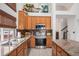 Well-lit kitchen featuring stainless steel appliances, granite countertops, and hardwood cabinets at 15776 E 107Th Way, Commerce City, CO 80022