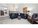 Spacious living room with a plush blue sectional, patterned pillows, and stylish decor, creating a welcoming and comfortable atmosphere at 15776 E 107Th Way, Commerce City, CO 80022