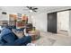 Bright living room with a ceiling fan, comfortable seating, and slider to a bedroom at 15776 E 107Th Way, Commerce City, CO 80022