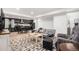 A cozy living room features an open floor plan with a modern kitchen and comfortable seating arrangements at 15776 E 107Th Way, Commerce City, CO 80022