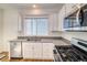 Modern kitchen with white cabinets, granite counters, and dishwasher at 23881 E 40Th Ave, Aurora, CO 80019