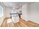 Open concept kitchen with island and white cabinetry at 23881 E 40Th Ave, Aurora, CO 80019