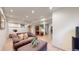 Cozy finished basement offers a comfortable living area with a sofa, adjacent desk, and exercise space at 13307 Humboldt Dr, Thornton, CO 80241