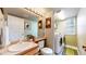Bathroom featuring a vanity, sink, toilet, mirror, and laundry area with a washer and dryer at 13307 Humboldt Dr, Thornton, CO 80241