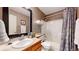 A clean bathroom is shown with a vanity, a shower-tub, and a decorative shower curtain at 13307 Humboldt Dr, Thornton, CO 80241