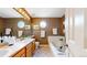 A bright bathroom shows a double sink vanity, a jacuzzi tub, and plenty of natural light at 13307 Humboldt Dr, Thornton, CO 80241