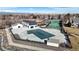 Aerial view of community pool, tennis courts, playground, and clubhouse at 13307 Humboldt Dr, Thornton, CO 80241