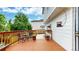 Backyard deck with outdoor seating and decorative planters with view of a fenced yard at 13307 Humboldt Dr, Thornton, CO 80241