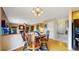 Dining room with hardwood floors that seamlessly connects to a cozy living area at 13307 Humboldt Dr, Thornton, CO 80241