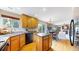 A bright kitchen featuring an island and black appliances, open to the dining room and patio at 13307 Humboldt Dr, Thornton, CO 80241