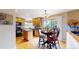 Bright kitchen featuring an island, black appliances, and an adjacent breakfast nook with a view at 13307 Humboldt Dr, Thornton, CO 80241