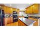 The kitchen showcases wood cabinets, black appliances, and stylish backsplash at 13307 Humboldt Dr, Thornton, CO 80241