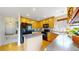 The spacious kitchen features black appliances, wood cabinetry, and island at 13307 Humboldt Dr, Thornton, CO 80241