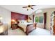 A primary bedroom boasts a large bed, an accent wall, and lots of natural light at 13307 Humboldt Dr, Thornton, CO 80241