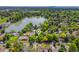 Stunning aerial view of a home near a lake, surrounded by lush greenery and mature trees in a quiet neighborhood at 3400 Garland St, Wheat Ridge, CO 80033