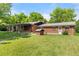 Well-maintained backyard with a mature lawn and brick exterior at 3400 Garland St, Wheat Ridge, CO 80033