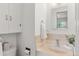 Clean and functional bathroom with a tiled sink, toilet and medicine cabinet at 3400 Garland St, Wheat Ridge, CO 80033