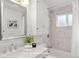 Fully renovated full bath features a modern design with sleek fixtures and marble tile at 3400 Garland St, Wheat Ridge, CO 80033