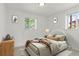 Bright bedroom with natural light, simple decor, and modern hardwood furniture at 3400 Garland St, Wheat Ridge, CO 80033