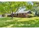 Charming brick home with a well-maintained lawn and mature trees providing shade and curb appeal at 3400 Garland St, Wheat Ridge, CO 80033