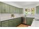 Well-lit kitchen with stainless steel appliances, light countertops and ample green cabinet space at 3400 Garland St, Wheat Ridge, CO 80033