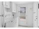 Bright laundry room with washer, dryer, storage and easy access to the back door at 3400 Garland St, Wheat Ridge, CO 80033