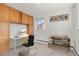 This office features a desk, storage cabinets, and is lit by a window at 3400 Garland St, Wheat Ridge, CO 80033