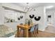 Well-lit dining area featuring a modern chandelier and unique wall decor with seating for four at 1862 Mallard Dr, Superior, CO 80027