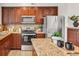 Modern kitchen featuring stainless appliances, stone countertops, and ample cabinet space with updated lighting at 1862 Mallard Dr, Superior, CO 80027