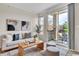 Bright living room featuring stylish decor, comfortable seating, and a sliding door to a private balcony at 1862 Mallard Dr, Superior, CO 80027