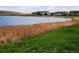 Scenic pond with lush reeds, vibrant grass, and nearby houses at 1862 Mallard Dr, Superior, CO 80027