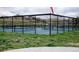 Enclosed tennis courts surrounded by a black fence, grass, and a distant view of houses at 1862 Mallard Dr, Superior, CO 80027
