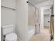 Bright bathroom showcasing a white toilet, tub with shower, and tile flooring at 3061 W 92Nd Ave # 14A, Westminster, CO 80031