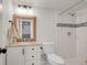 Bathroom featuring a granite countertop vanity, framed mirror, and tiled shower at 3061 W 92Nd Ave # 14A, Westminster, CO 80031