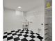 Laundry room with black and white checkered flooring and a utility sink at 3061 W 92Nd Ave # 14A, Westminster, CO 80031