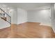 Bright living room with gleaming hardwood floors, white walls, and a staircase at 3061 W 92Nd Ave # 14A, Westminster, CO 80031