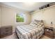 Bedroom showcasing a twin-sized bed with a patterned comforter, side tables, a window and closet for ample storage at 6132 W 113Th Ave, Westminster, CO 80020
